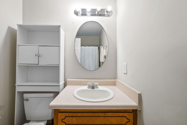 full bath featuring toilet and vanity