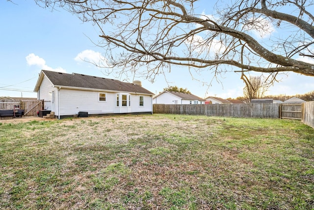 view of yard featuring a fenced backyard and central AC unit