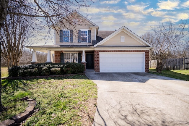 view of front of home with a porch, fence, concrete driveway, an attached garage, and brick siding