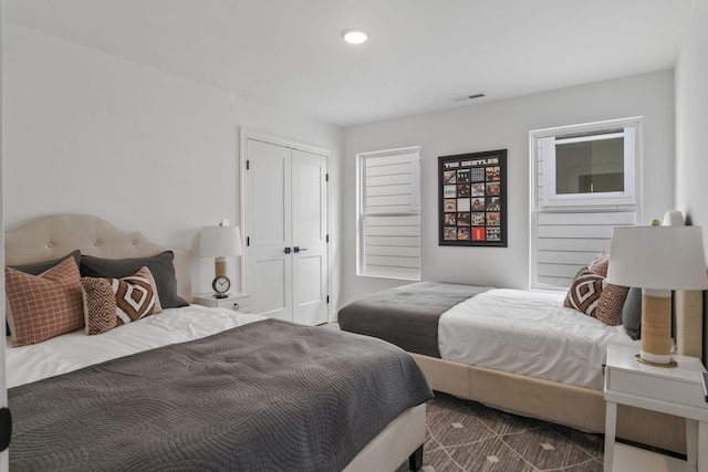 bedroom with a closet, visible vents, and recessed lighting