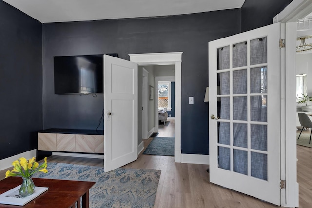 interior space with wood finished floors and baseboards