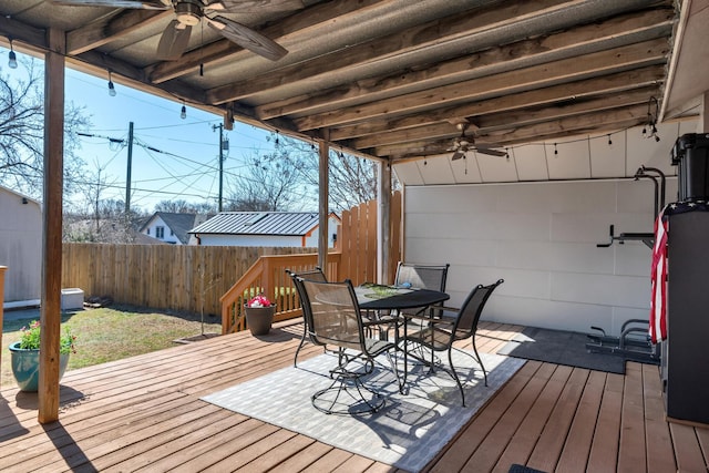 wooden deck featuring a fenced backyard, outdoor dining area, and a ceiling fan