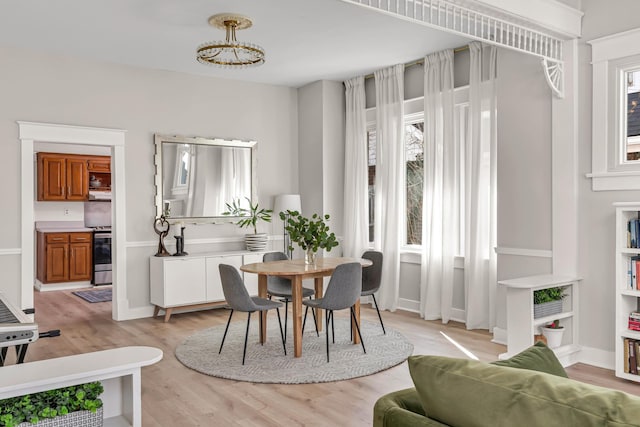 dining room featuring light wood-style floors and baseboards