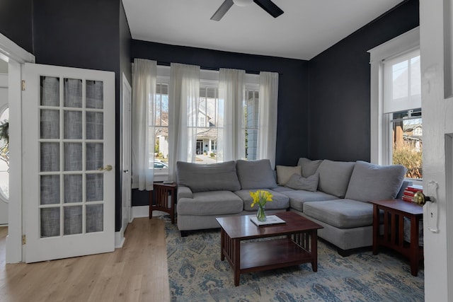 living area featuring a ceiling fan and wood finished floors