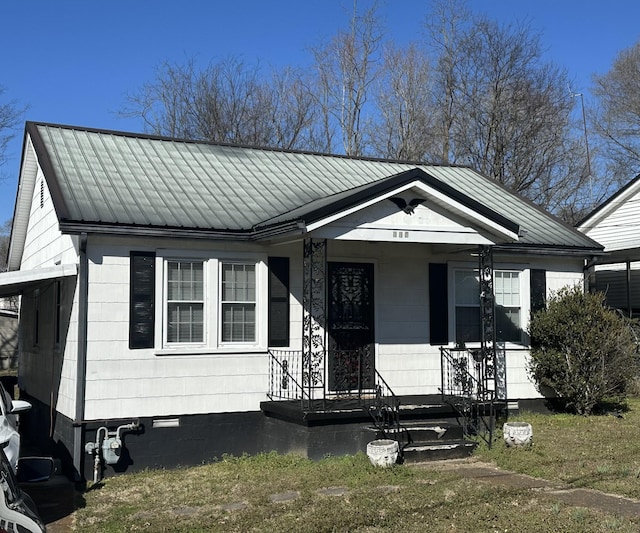 bungalow featuring crawl space, covered porch, and metal roof