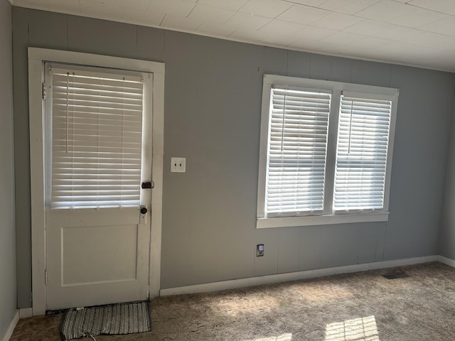 interior space featuring carpet floors and baseboards