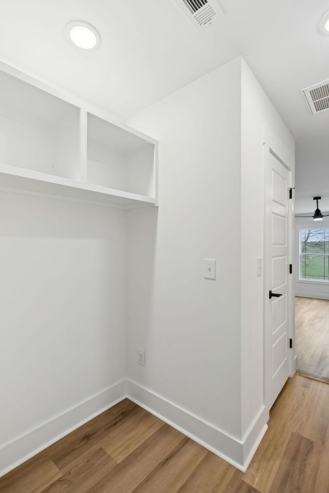 interior space with visible vents, baseboards, and wood finished floors