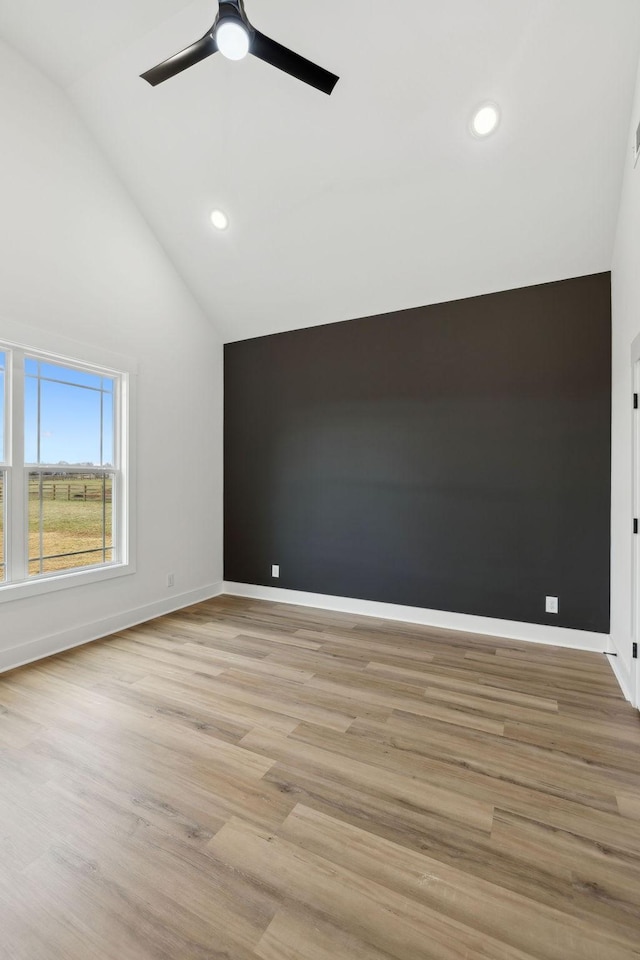 unfurnished room featuring recessed lighting, light wood-style flooring, and baseboards