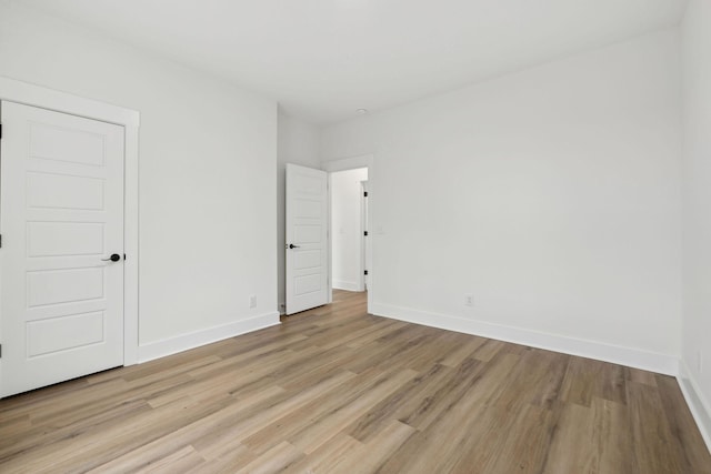 unfurnished bedroom featuring light wood-style floors and baseboards