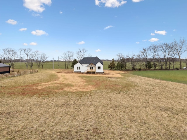 view of yard featuring a rural view and fence