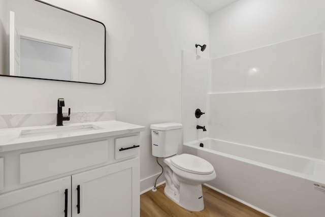 full bathroom featuring toilet, shower / bath combination, wood finished floors, and vanity