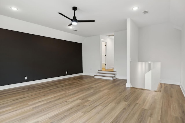 unfurnished living room with light wood-style floors, visible vents, baseboards, and a ceiling fan