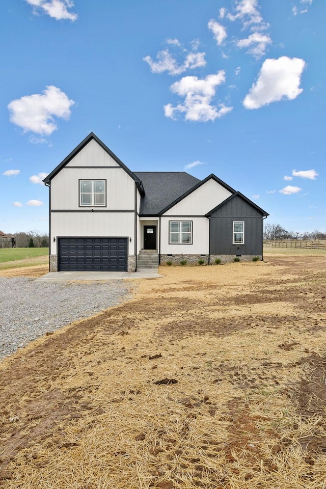 modern inspired farmhouse featuring roof with shingles, driveway, and an attached garage