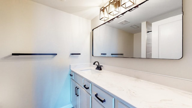 bathroom featuring baseboards, visible vents, and vanity