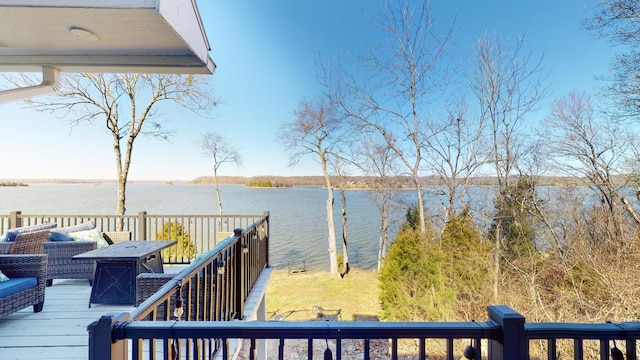 wooden terrace featuring a water view