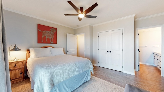 bedroom with a closet, crown molding, light wood-style flooring, and baseboards