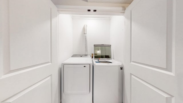 laundry area featuring laundry area, washer and clothes dryer, and a textured ceiling