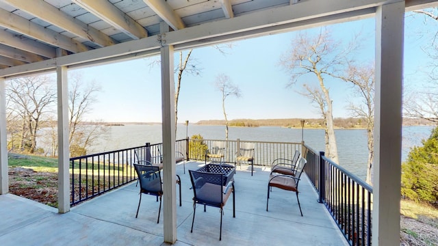 view of patio / terrace featuring a water view and a fire pit