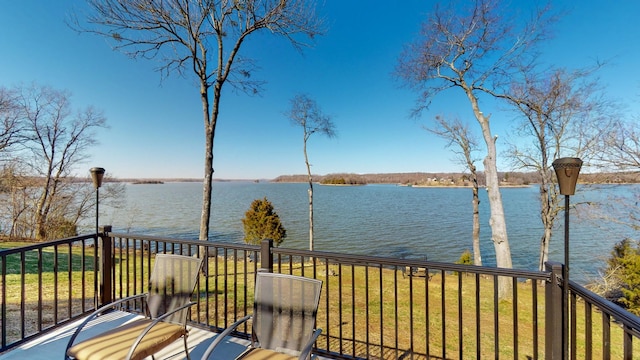 deck with a lawn and a water view