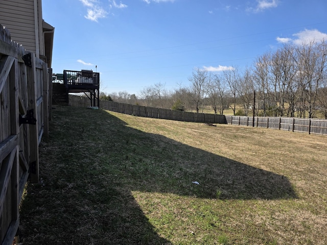 view of yard featuring a wooden deck and a fenced backyard