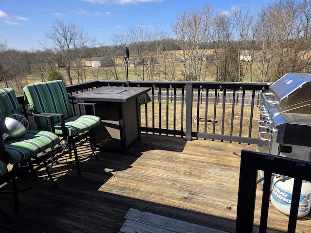 wooden terrace featuring a grill