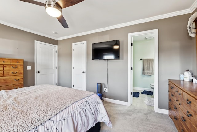 bedroom featuring baseboards, ornamental molding, light carpet, a closet, and ensuite bath