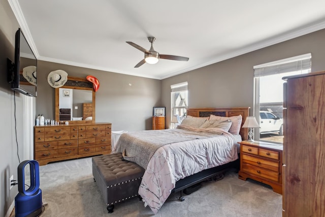 bedroom with crown molding, ceiling fan, and carpet floors