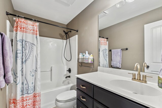 bathroom featuring toilet, vanity, and shower / bath combo with shower curtain