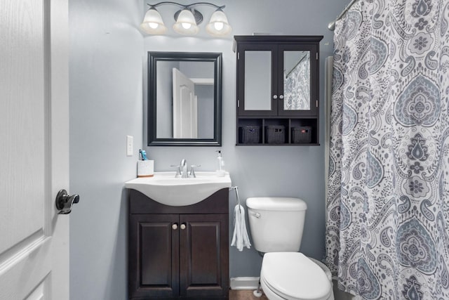 full bathroom with toilet, vanity, and a shower with curtain