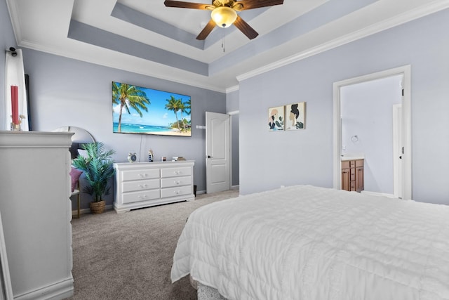 bedroom featuring baseboards, a tray ceiling, ornamental molding, carpet flooring, and a ceiling fan