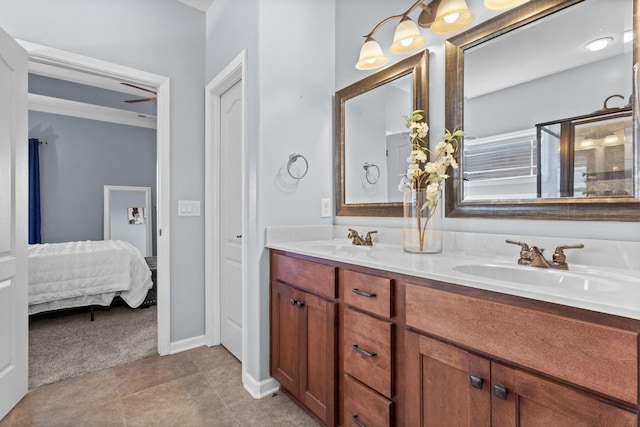 ensuite bathroom with tile patterned floors, double vanity, ensuite bathroom, and a sink