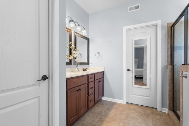 bathroom with visible vents, connected bathroom, double vanity, a stall shower, and tile patterned floors