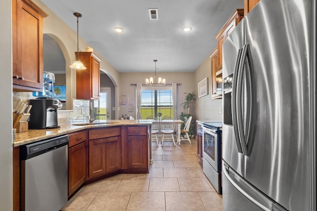 kitchen featuring visible vents, backsplash, light tile patterned floors, stainless steel appliances, and a sink