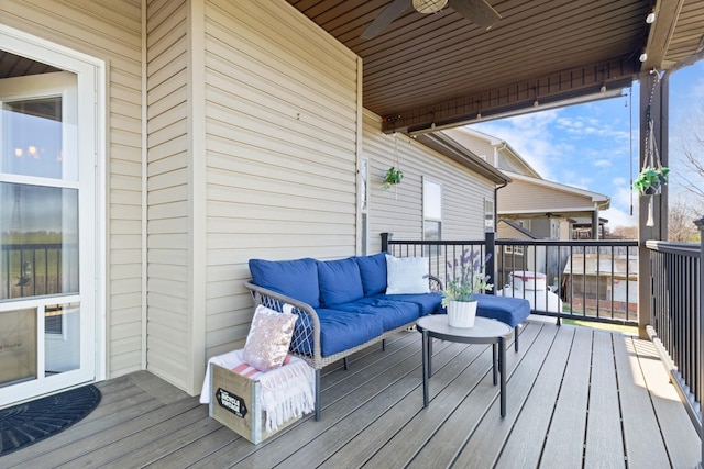 deck with an outdoor living space and a ceiling fan