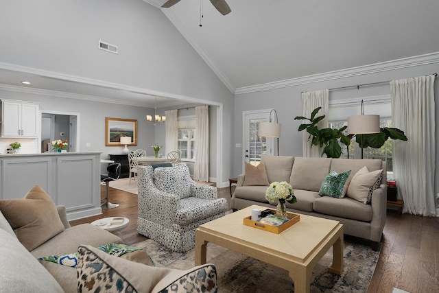 living room featuring visible vents, ornamental molding, wood finished floors, high vaulted ceiling, and ceiling fan with notable chandelier