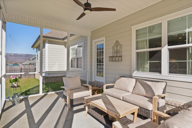 sunroom featuring a ceiling fan