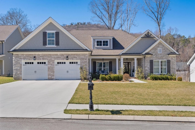 craftsman house featuring a garage, a shingled roof, concrete driveway, stone siding, and a front yard