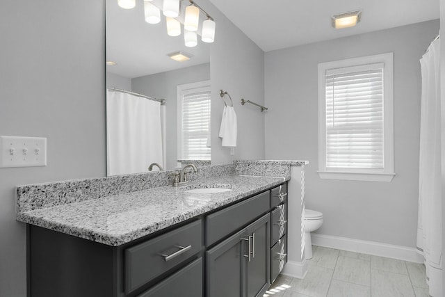 bathroom featuring toilet, visible vents, baseboards, and vanity