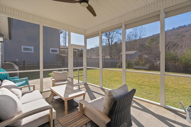 sunroom / solarium with a ceiling fan