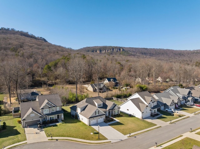 drone / aerial view with a residential view and a wooded view