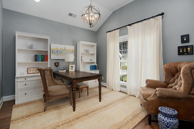 office area featuring lofted ceiling, wood finished floors, visible vents, baseboards, and an inviting chandelier