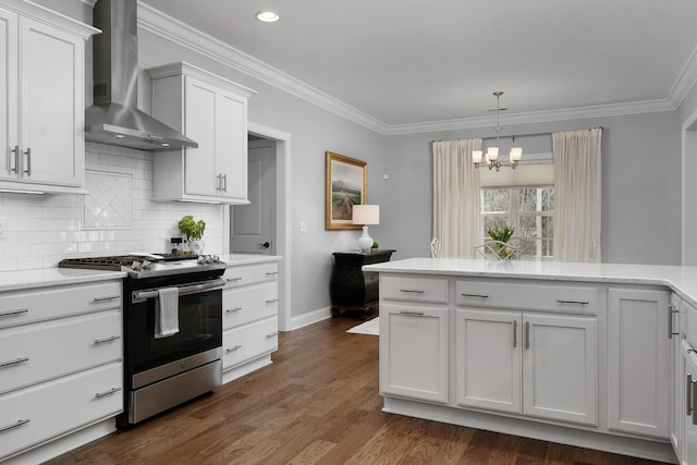 kitchen featuring dark wood-style floors, stainless steel range with gas cooktop, decorative backsplash, ornamental molding, and wall chimney exhaust hood