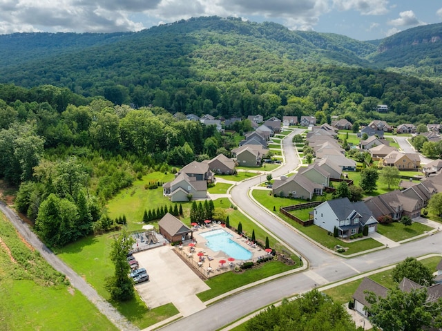 aerial view with a mountain view, a residential view, and a view of trees