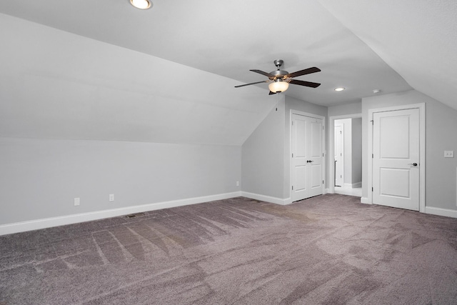 additional living space with carpet, vaulted ceiling, baseboards, and ceiling fan