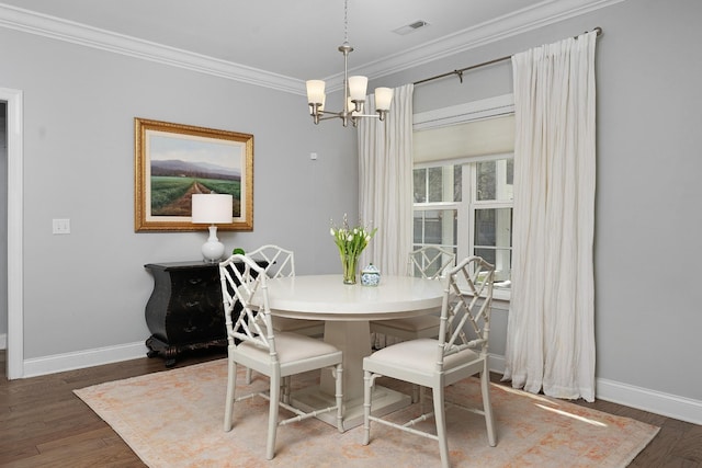 dining area featuring ornamental molding, visible vents, a notable chandelier, and wood finished floors