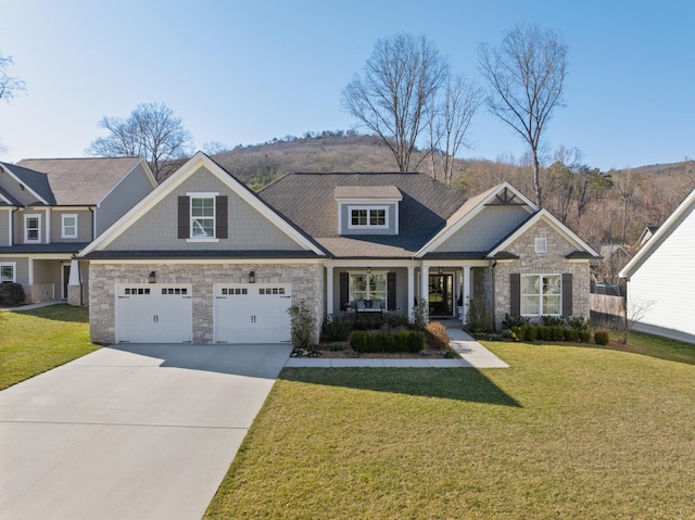 craftsman house with driveway, a garage, stone siding, covered porch, and a front lawn