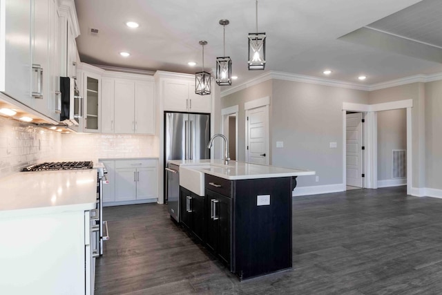 kitchen featuring tasteful backsplash, freestanding refrigerator, light countertops, and white cabinetry