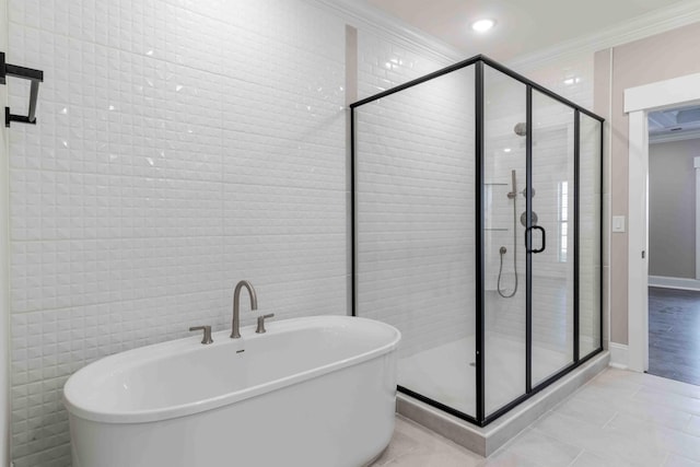 full bathroom featuring a freestanding bath, a stall shower, tile patterned flooring, and crown molding