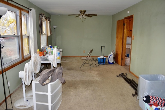 carpeted dining space featuring ceiling fan, baseboards, and a healthy amount of sunlight