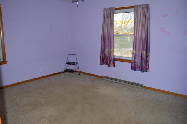 unfurnished room featuring baseboards, a baseboard heating unit, and carpet flooring